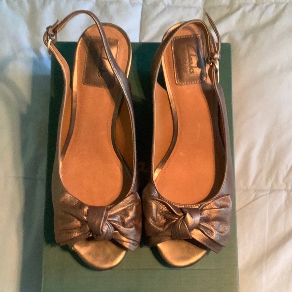Clarks women’s bronze leather wedges with cork soles.